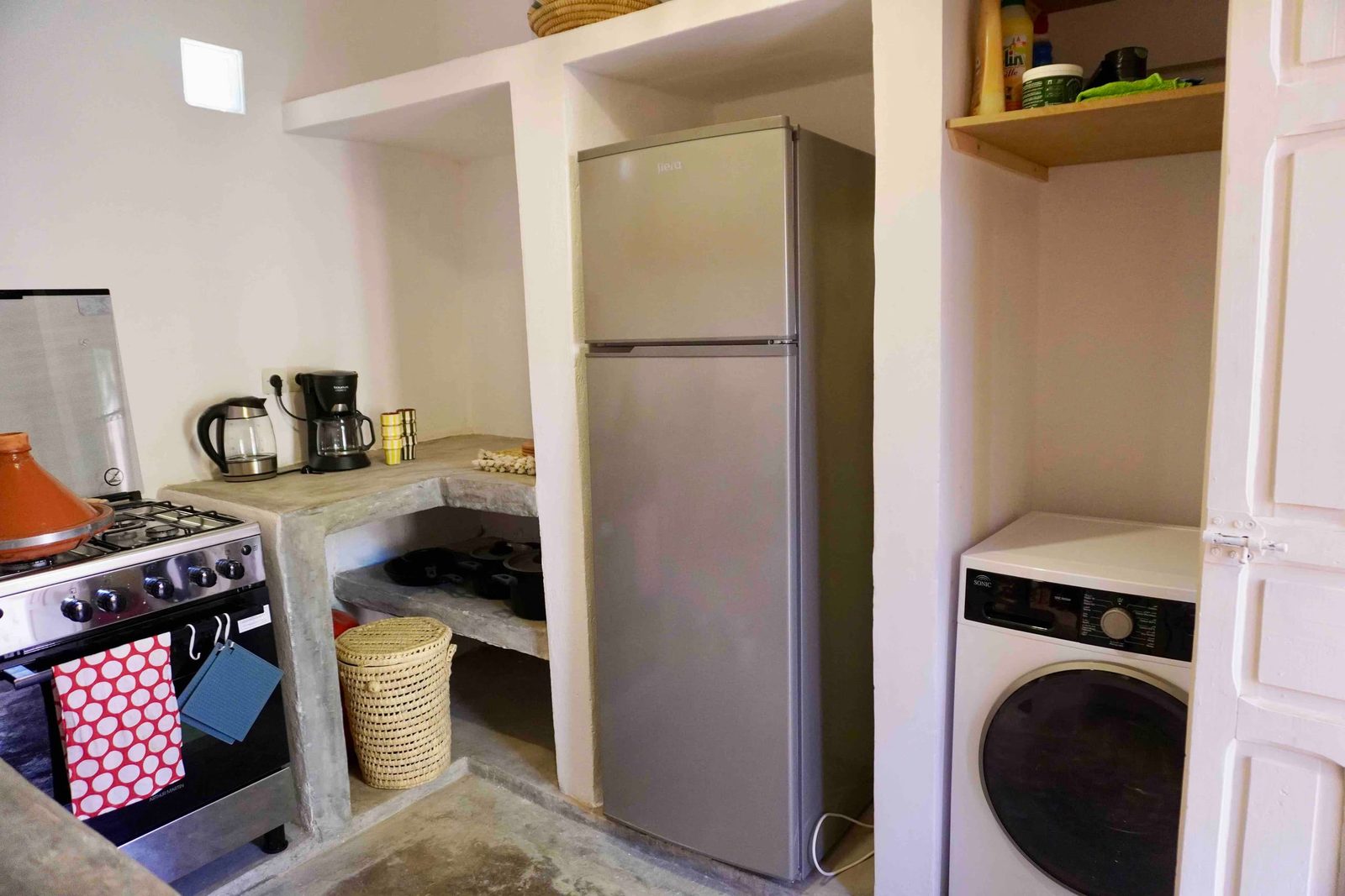 La cuisine équipée : réfrigérateur, four, cuisinière et lave-linge